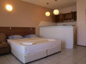 a bedroom with a large bed in a room at Guestrooms Maria Antoaneta in Sozopol