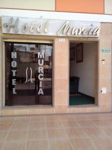 a store window with a sign that reads my furniture at Hotel Murcia in Guayaquil