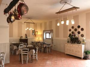 a restaurant with tables and chairs and pots and pans at Agriturismo Il Rifugio in Battipaglia