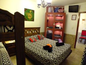 a bedroom with a bed with two towels on it at La Casa de Mia Mama in Salta +29 photos