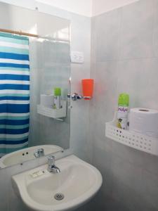a bathroom with a sink and a mirror at Playa Los Cocos in Santa Marta