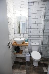 a white bathroom with a sink and a toilet at Kohili apartments in Pefkochori +21 photos