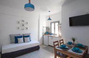 a living room with a bed and a table at Kohili apartments in Pefkochori