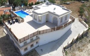 an overhead view of a large white house with a swimming pool at Acropolis Sea View Villa in Polis Chrysochous