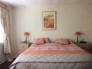 a bedroom with a large bed with red pillows at Rhiwiau Guesthouse in Llanfairfechan