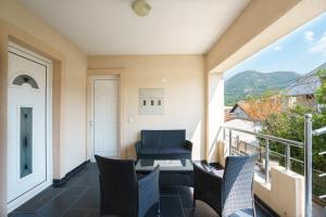 a balcony with chairs and a table and a view at Apartments Lora in Bar