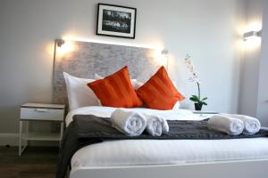 a bedroom with a bed with towels on it at Westciti Caroco Aparthotel in Croydon