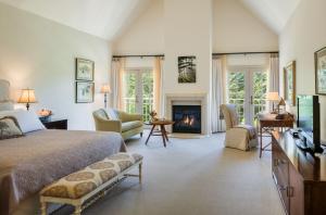 a bedroom with a bed and a fireplace at Seal Cove Inn in Half Moon Bay
