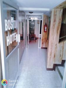 a lobby of a hotel with a sign that reads boston hotel at Hotel Boston in Guayaquil
