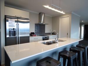 a kitchen with a sink and a refrigerator at Southholm in Lake Tekapo