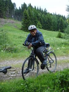 a man riding a bike down a dirt road at Pension MAX in Pernink