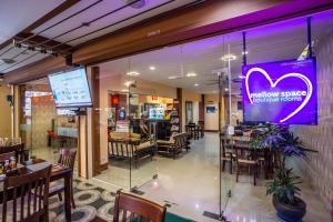 a restaurant with a purple sign on the window at Mellow Space Boutique Rooms in Karon Beach