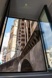 a view of a clock tower from a window at Amalfi Cathedral Suite in Amalfi