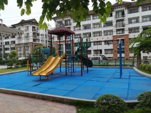 a playground in front of a building at Apartelle D' Oasis in Davao City