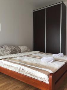 a bedroom with two beds with white sheets at Happy Orange in Podgorica