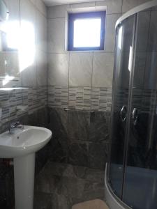 a bathroom with a sink and a shower at Aleksandrovo Apartments in Aleksandrovo +27 photos