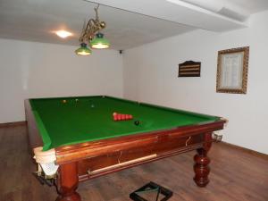 a pool table in a living room with afits at Aleksandrovo Apartments in Aleksandrovo