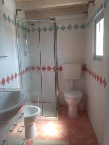 a bathroom with a shower and a toilet and a sink at B&B Lacurte in Martano