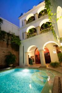 
a large swimming pool with a large window at Hotel San Pedro Suite in Cartagena de Indias
