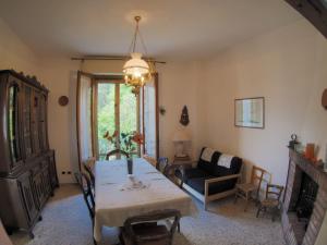 a living room with a table and a couch at Casa DUILIA in Castellina in Chianti