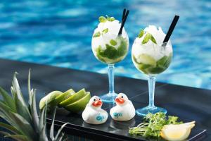 two glasses of ice cream and toy ducks next to a pool at V Spa & Conference Hotel in Tartu