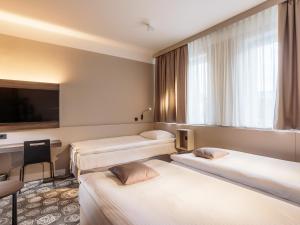Una cama o camas en una habitación de Hotel Center Novo Mesto