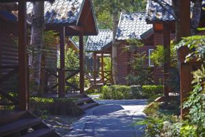 a walkway in front of a wooden building at New Era Art Resort and Spa in Puli