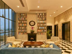 a living room with a couch and a fireplace at The Waverly Hotel & Residences in Bangalore