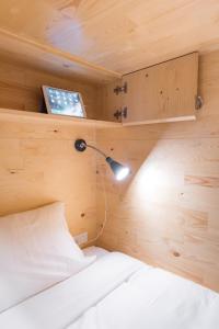 a bedroom with a bed and a lamp and aaptop at Norn Yaowarat Hotel in Bangkok
