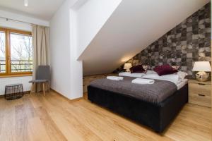 Posteľ alebo postele v izbe v ubytovaní udanypobyt Apartamenty Tuwima