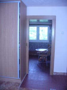 an open door to a room with a table and a window at Piteľová-Babica in Pitelová