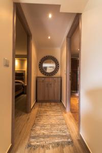 a hallway with a mirror and a rug at Dryades Apartments & Studios in Skala Potamias