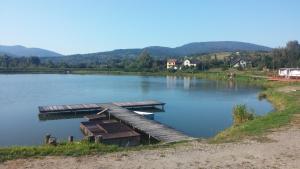 a dock in the middle of a lake at Domek Gloria nad Jeziorem Żywieckim in Żywiec