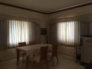 a dining room with a table and chairs at Peaceful homestay in Rawai Beach