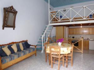 a living room with a table and a loft bed at Halki Townhouse in Halki