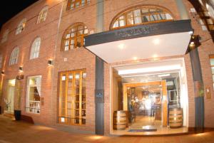 a store front of a brick building with a doorway at San Martin Hotel y Spa in San Rafael