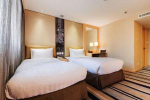Katil atau katil-katil dalam bilik di Metropark Hotel Mongkok