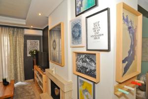 a living room with pictures on the wall at Agrinio ART Suites in Agrinio