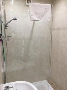 a bathroom with a shower with a toilet and a sink at The Greannan Bed & Breakfast in Blackwaterfoot