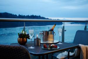 a table with a bottle of champagne and glasses at Ice House Hotel in Ballina