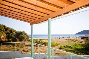 a view of the beach from the balcony of a beach house at Aselinos Suites in Koukounaries