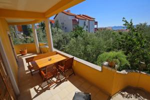 a balcony with a wooden table and chairs at Villa Zubčić in Zadar