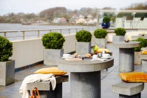 a table with a plate of food on a balcony at Ice House Hotel in Ballina