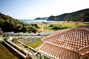 a view of a house with a view of the beach at Aselinos Suites in Koukounaries