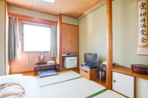 Postel nebo postele na pokoji v ubytování Hotel Los Inn Kochi