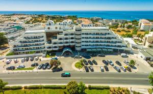 an aerial view of a large building with a parking lot at Hotel Apartamento Brisa Sol in Albufeira