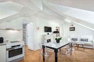 a kitchen and living room with a table and chairs at Les Demoiselles à Versailles - Au Pied du Château in Versailles