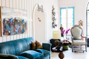 a living room with a blue couch and a chair at Residenza d'Epoca Albergo Quattro Fontane in Venice-Lido