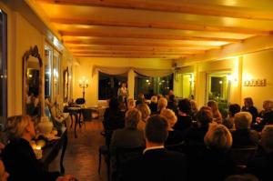 a crowd of people sitting in a room at Landsitz Kapellenhöhe, Hotel Garni in Wiedenbrügge
