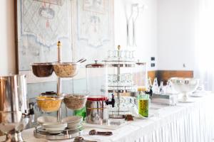 a buffet line with bowls and other food ingrediants at Residenza d'Epoca Albergo Quattro Fontane in Venice-Lido